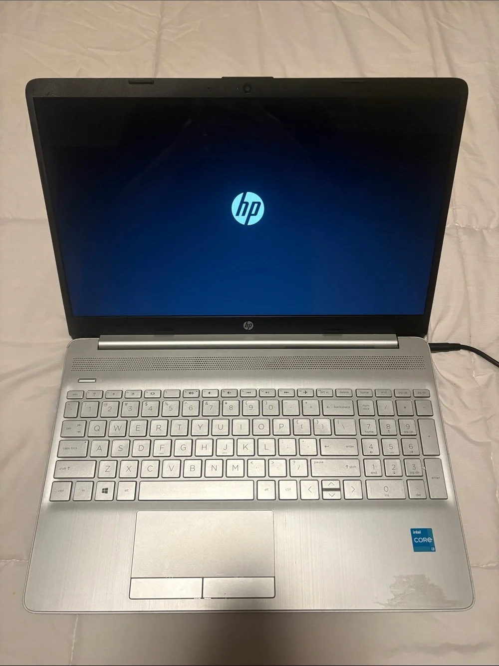 HP Silver Laptop with Charger and Sticker Accents